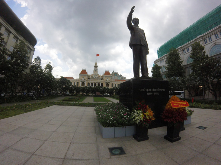 ho chi minh monument in saigon, behind teh statue is the city hall