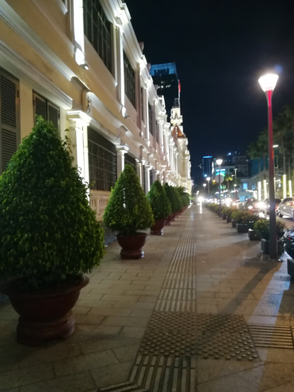 a side of the city hall building in saigon during the night