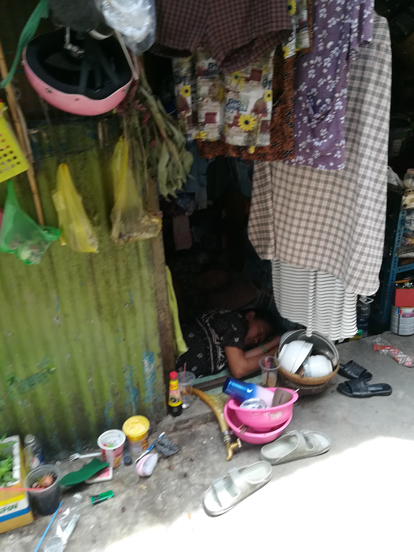 a woman sleeping in a small room in a corridor in ho chi minh