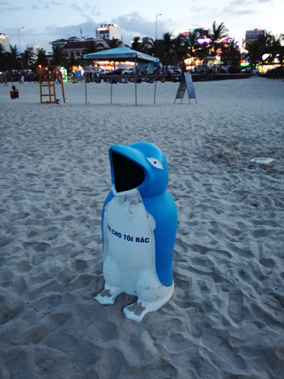 trash can on the beach in da nang with a penguin shape