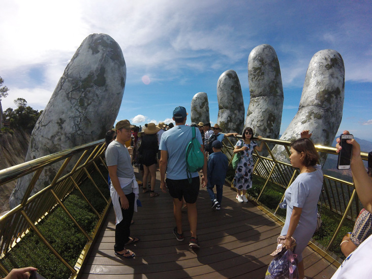 golden bridge in ba na hills, it is a bridge hold by two hands that come up from the mountain