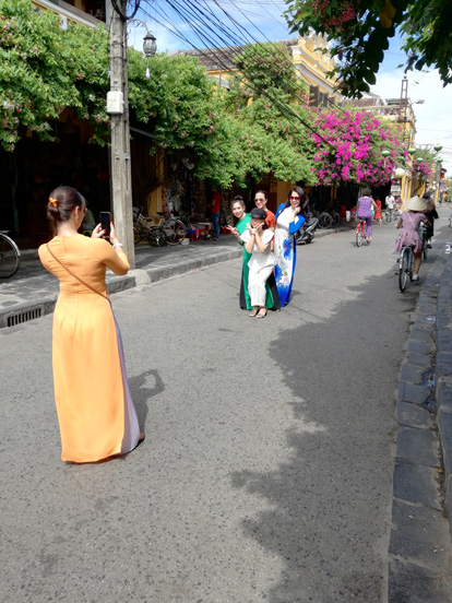 some girls taking pictures in the beatiful hoi an