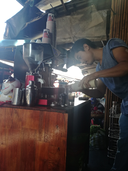 a guy making coffe in hoi an