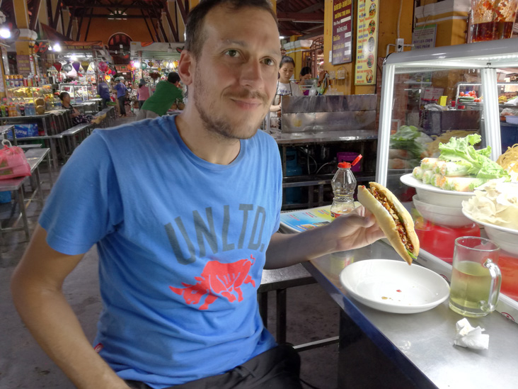 tasting a banh mi in hoi an old market