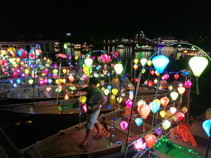 a boat with lot of laterns in hoi an. they are for tourism