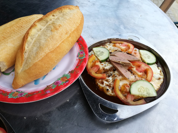 french bread with eggs, vegetables and something else for breakfast in hoi an