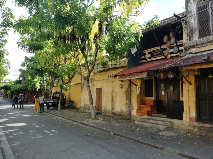 a couple posing for pictures in hoi an