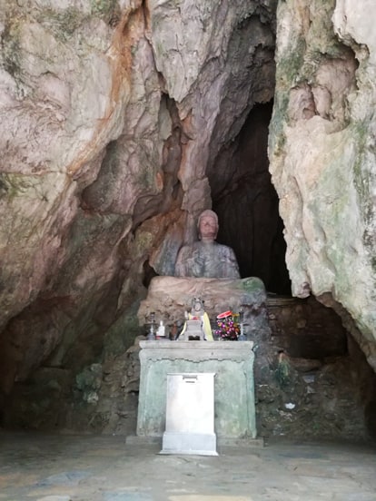 buda in marble mountians in da nang with a small altar