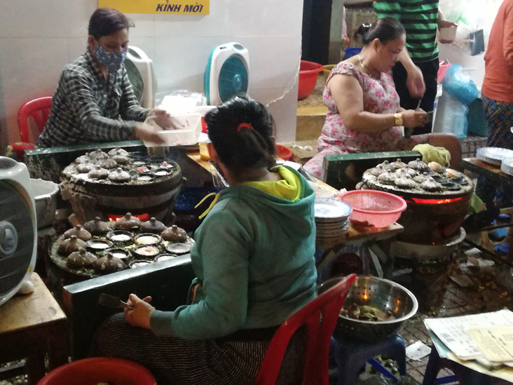 street food in nha trang, a group of women cooking delicius food