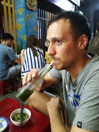 drinking a green juice in a street food place in nha trang