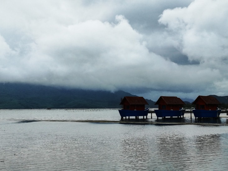 houses in the middle of a lake on the way to da nang airpot from hue