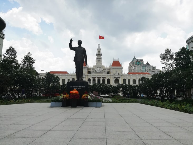 Ho Chi Minh in Saigon city vietnam and behind the statue the reunification palace
