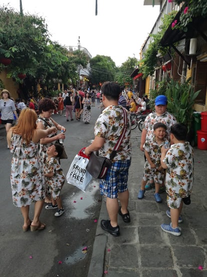 a family walking around in hoi an old town