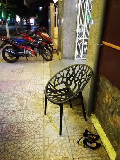 a pair of shoes on the street in vietnam, because it isn't allowed to enter with them in some places